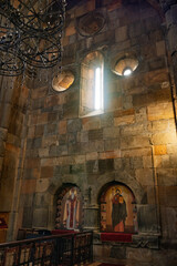 The inside of a church with a window that lets in sunlight