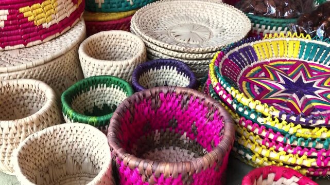 Colorful Traditional Woven Baskets at a Pakistani Handicraft Stall, The baskets feature vibrant colors, intricate weaving patterns, and authentic folk craftsmanship, commonly seen at local festivals 
