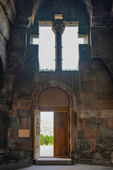 Armenian Hovhannavank monastery church doorway is open, and the sunlight is shining through the window