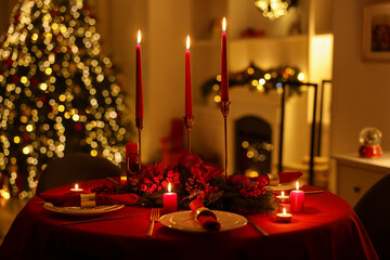 Stylish Christmas table setting with plates, festive decor and burning candles indoors