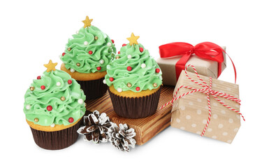 Christmas tree shaped cupcakes, pine cones and gift boxes isolated on white