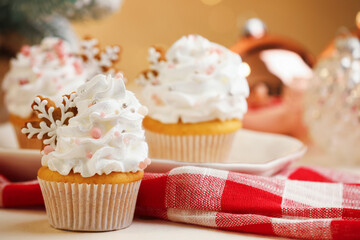 Festive cupcakes with cookies on white table, closeup. Christmas treat