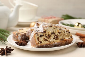 Slices of Stollen (traditional Christmas cake) served on white table, closeup