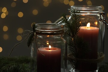 Beautiful Christmas lanterns and festive decor against blurred lights, closeup. Bokeh effect