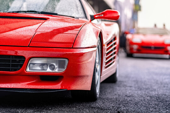 Brno, Czech Republic - October 10, 2025: Red sports car Ferrari 512 TR Testarossa at the pits on the racing circuit. Old rare Italian fast car. Detail on the light.