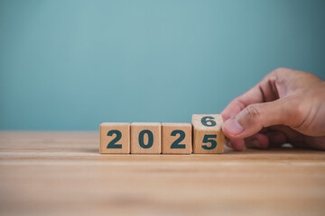 Wooden cube blocks for the transition from 2025 to 2026. Countdown to 2026. Load year from 2025 to 2026. New year start concept.