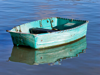 Skiff Rowboat Reflected in Calm Harbour Waters
