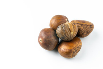 Close-up of fresh brown chestnuts isolated on white background, showing natural texture and detail. Ideal for healthy food, nut ingredient, autumn harvest, and organic nutrition concepts.