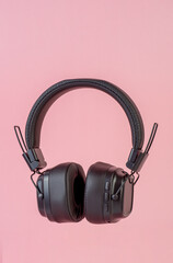 Two-tone silver and brown wireless headphones, Headphones isolate on pink background. Wireless headphones in brown.