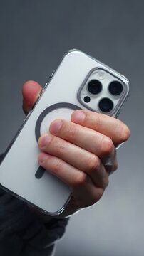 A person holding a white mobile phone with a camera.
Lens on the back of the smartphone.
Photo taken with a phone and a modern camera with zoom on the phone.
Lens, smartphone, phone, mobile