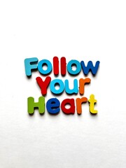 Follow your heart inspirational message with colorful three-dimensional letters