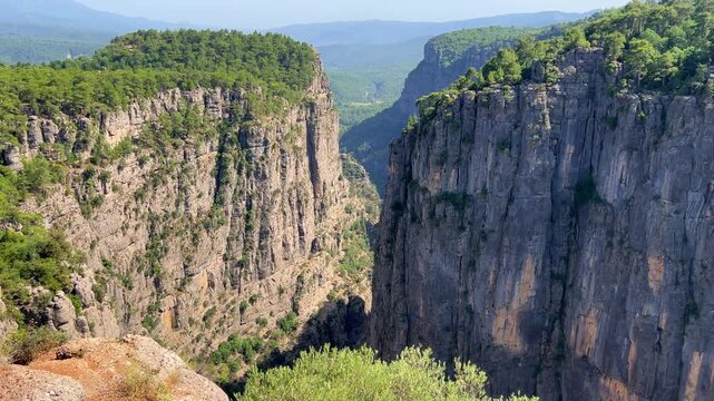 A mountain valley landscape with forests and cliffs. Huge rocks and rocky outcrops. A beautiful deep canyon with lots of tourists. A bird's-eye view of the Tasi Canyon. T&uuml;rkiye