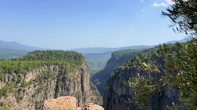 A mountain valley landscape with forests and cliffs. Huge rocks and rocky outcrops. A beautiful deep canyon with lots of tourists. A bird's-eye view of the Tasi Canyon. T&uuml;rkiye