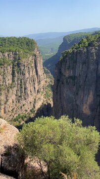 A mountain valley landscape with forests and cliffs. Huge rocks and rocky outcrops. A beautiful deep canyon with lots of tourists. A bird's-eye view of the Tasi Canyon. T&uuml;rkiye