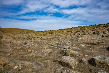 A rocky hillside with a clear blue sky