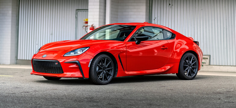 Brno, Czech Republic - October 10, 2025: Red Toyota GR86 sports car parked outside in front of a garage. Small fast Japanese car for driving pleasure.