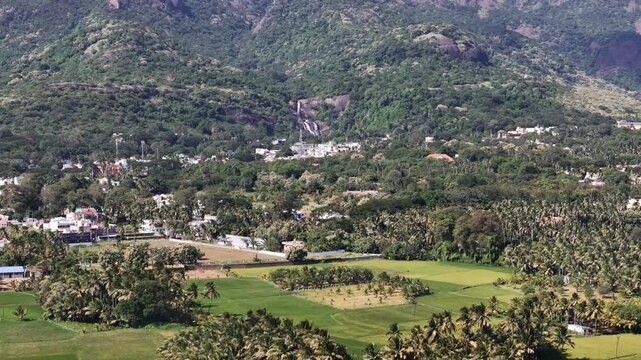 Courtallam falls, the &ldquo;Spa of South India,&rdquo; captured from above &mdash; forested hills, gushing waterfalls, and vibrant town colors at the foot of the Western Ghats.