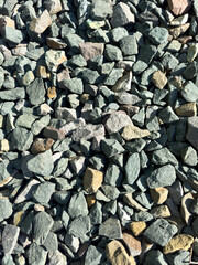 A pile of rocks with a few brown ones