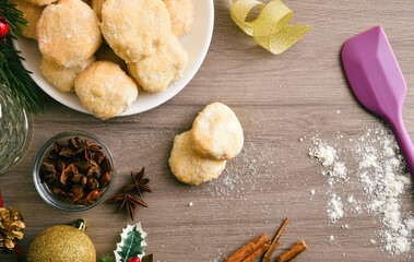 Freshly prepared anise cookies on a wooden kitchen bench