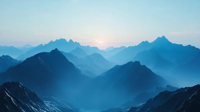 Mountain range in blue mist at sunrise