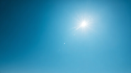 A bright sun shines in a clear blue sky, symbolizing warmth and positivity in nature's beauty.