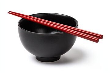 A black bowl with red chopsticks resting across, isolated on white