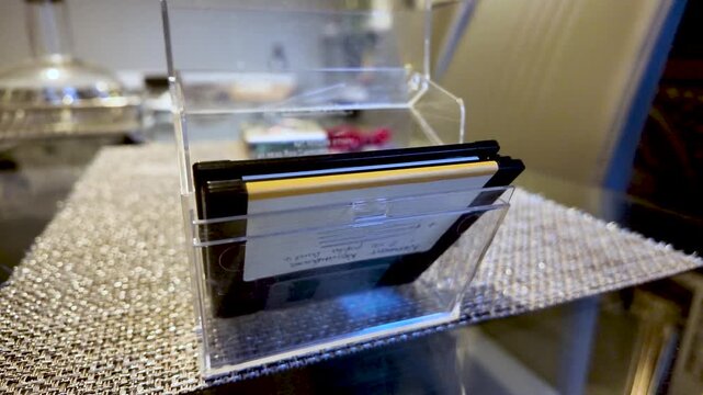 Transparent acrylic display case houses floppy disks, creating a vintage computer storage aesthetic for desks.