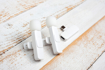 Two wireless microphones and a transmitter for your phone.