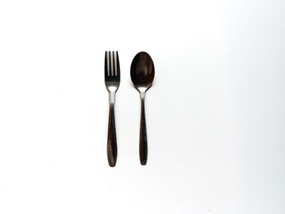 A neatly arranged spoon and fork set on a clean background, showing simple dining essentials suitable for food styling, kitchenware catalogs, tableware themes.