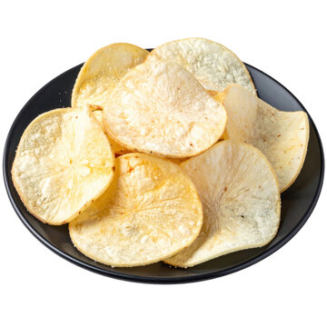 Crispy and thick-cut caribbean cassava chips served on a dark plate, overhead view, isolated on white background for a gluten-free snack alternative