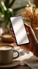 Modern lifestyle hand holding smartphone mockup with blank screen cozy environment digital device concept