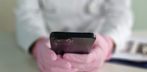 Healthcare, hospital and hands of doctor with phone for social media, research and online consulting. Communication, insurance and man with smartphone for wellness app