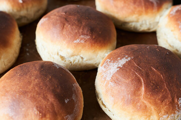 Freshly baked buns on a baking sheet. Close-up.