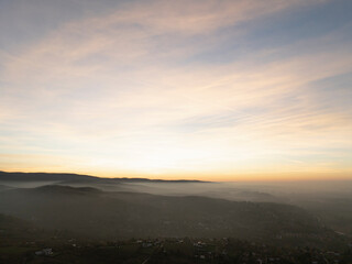 Tranquil Sunrise Over Misty Hills and Rural Valley.