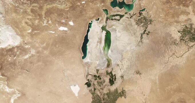 View from above on drying lake in arid region. Camera is moving forward and left. Animation based on image by NASA
