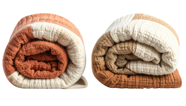 Two rolled, textured blankets in a patchwork of rust, beige, and white hues
