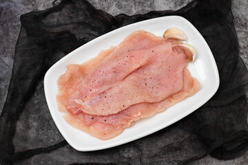 Fresh Raw turkey steak with black pepper