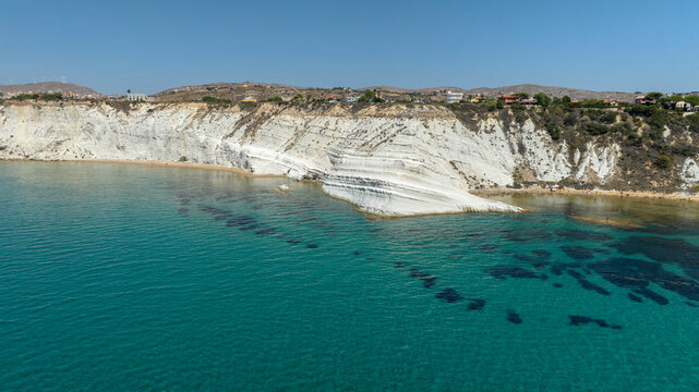 Panorama of the Scala dei Turchi (Stair of the Turks or Turkish Steps) on the coast of Realmonte, near Agrigento, Sicily, Italy. It's a marl cliff and tourist attraction. The sea is turquoise.