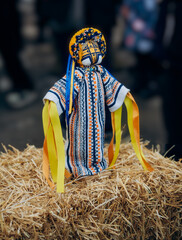 Ukrainian motanka doll with embroidered dress on hay