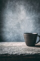 Dark Grey Mug With Steam On Rustic Table