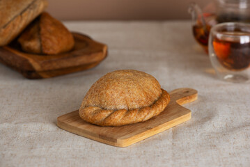 Homemade baked pies with apples, pears, and cinnamon made from whole grain flour with green tea on a table.