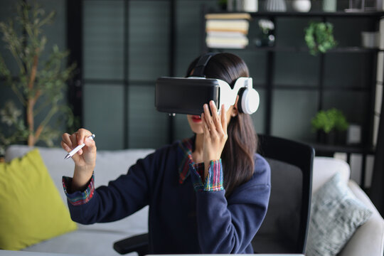 Women wear VR headsets at work for virtual collaboration, designing 3D models, immersive training, and analyzing data in a virtual space.