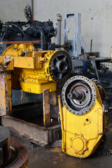 Heavy-duty allison transmission assembly and final drive unit disassembled for maintenance in a professional industrial workshop setting.