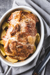 Baked pork with potatoes in baking dish. Top view