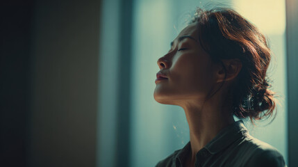 Woman relaxing in natural sunlight with eyes closed