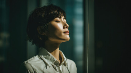 Woman relaxing in natural sunlight with eyes closed
