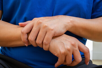 Wrist pain may result from strain, sprain, or tendon injury. Copy space for medical care ads.