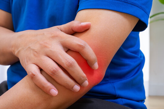 Elbow pain from bone or tendon injury affects work and daily tasks. Copy space for medical care ads.