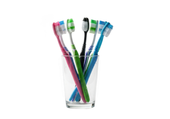 Colorful toothbrushes in glass isolated on black background concept