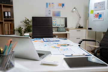 workspace area with laptop tablet smartphone and paperwork on the table in the office concept.